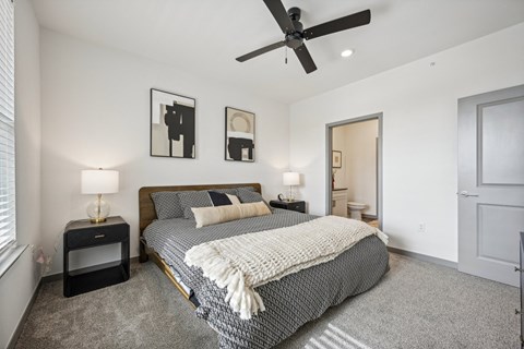 a bedroom with a bed and a ceiling fan at The Quarry Luxury Apartment Homes, Colorado, 80526